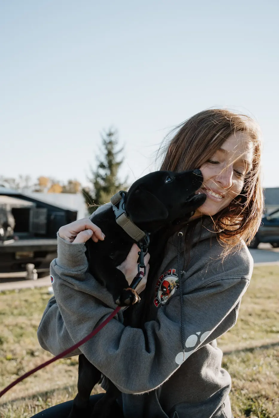 Trainer cuddling a young dog